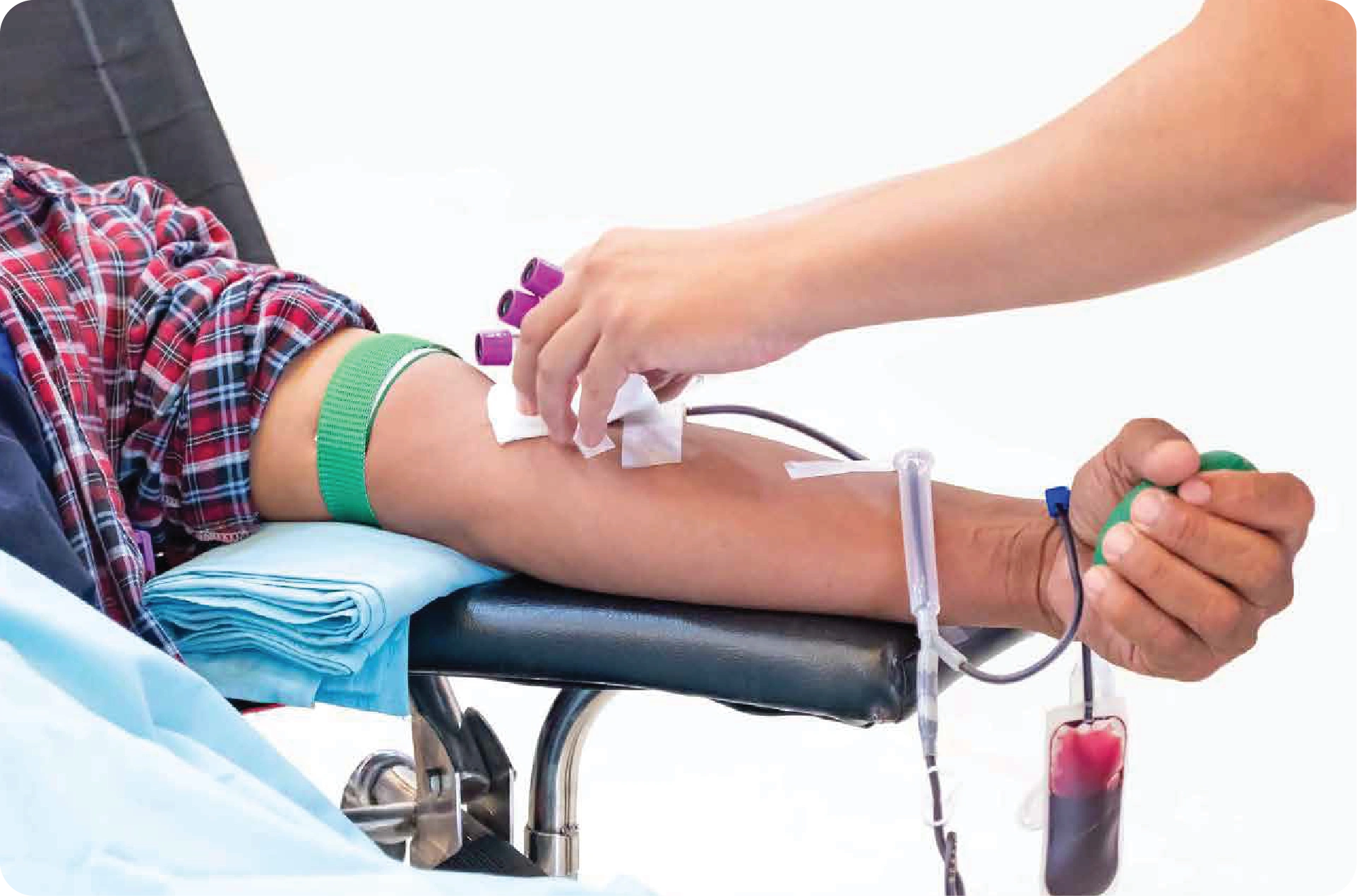 Person donating blood during a community blood donation drive with collection bag and medical supervision